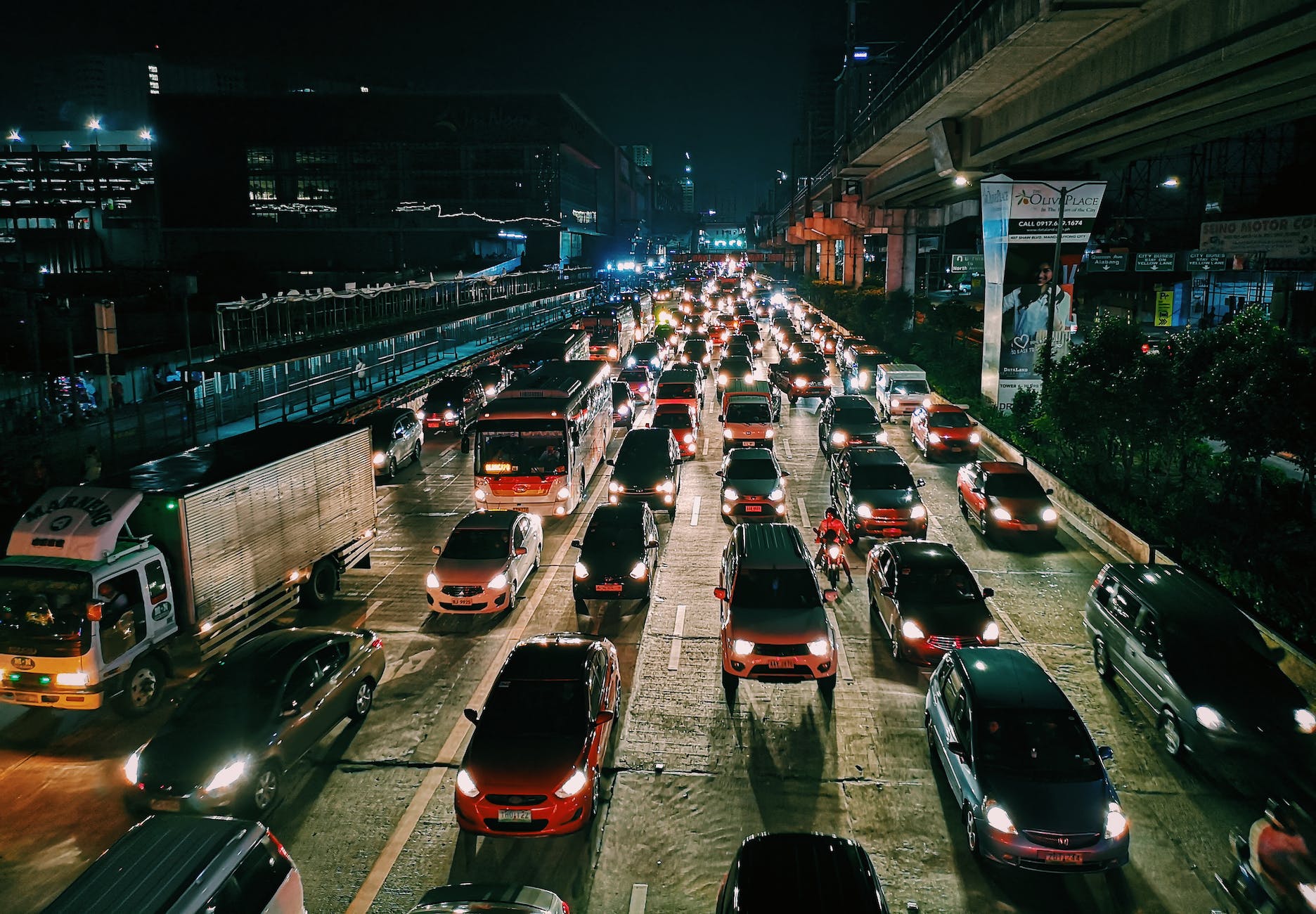 photo of vehicles on road during evening